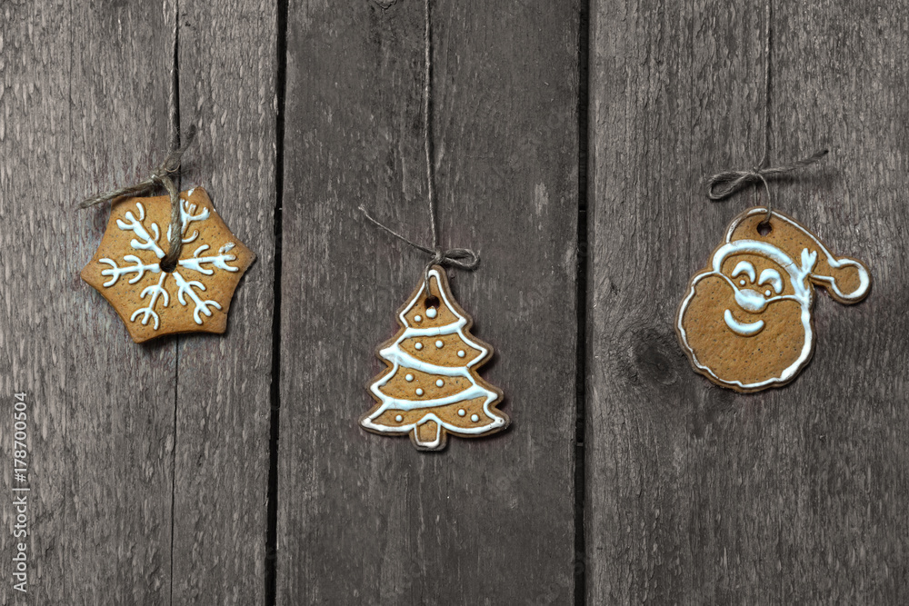 Christmas cookies hang near a wooden wall on a rope Christmas cookies hang near a wooden wall on a rope