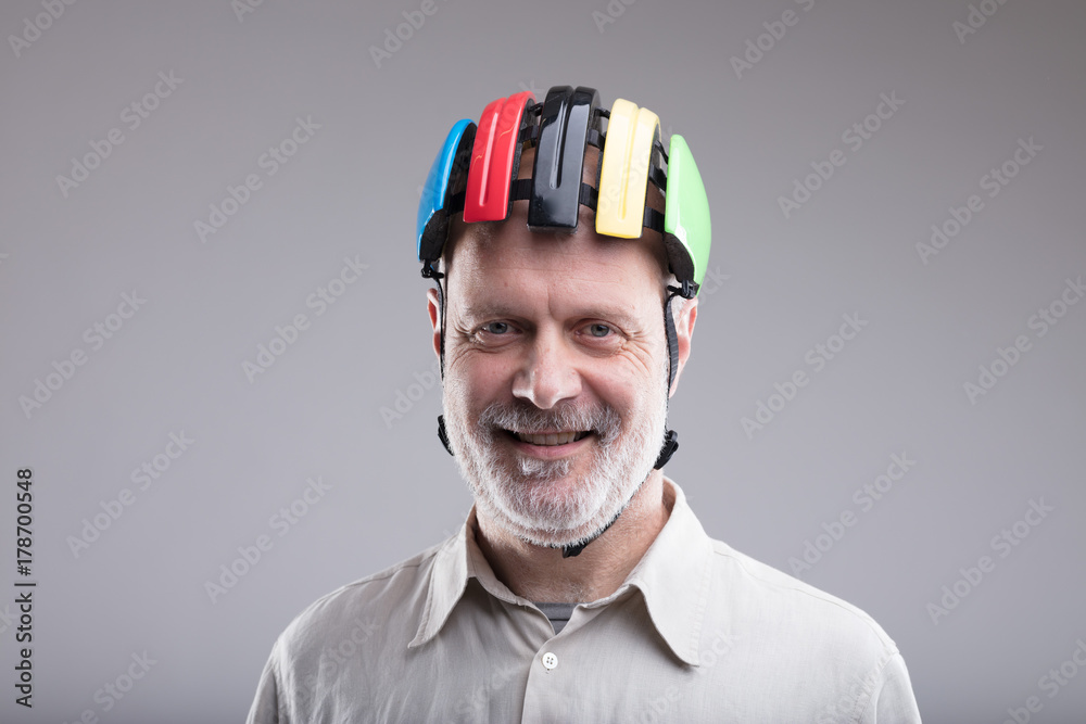 Fototapeta premium smiling old man wearing a bike helmet