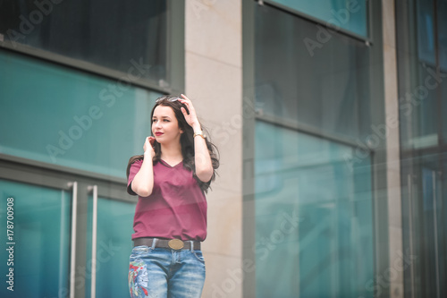 Outdoor lifestyle hipster teen girl posing alone at city center