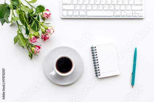 woman desk design with petals and notebook white background top view mock-up