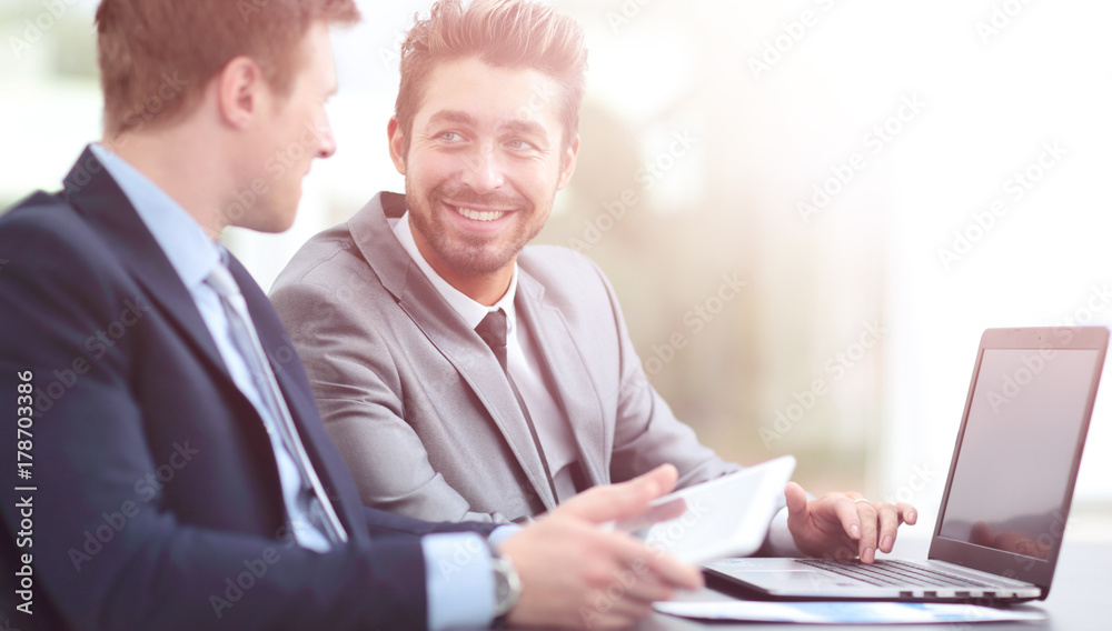 Two handsome businessmen working together on a project in the of Two handsome businessmen working together on a project in the of