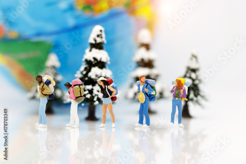 Miniature people, backpackers with globe walking to destination. Concept of Travel around the world and the adventure.