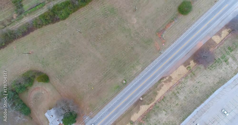 Aerial drone footage over a busy rural road