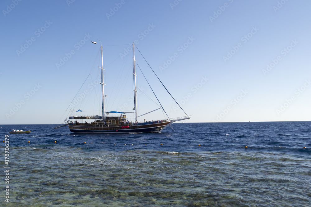 the sailer goes along the waves and pulls the boat behind him the sailer goes along the waves and pulls the boat behind him