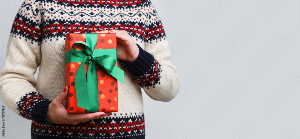 Unrecognizable woman holding christmas gift Unrecognizable woman holding christmas gift