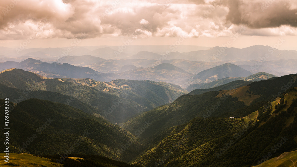 Obraz premium Beautiful view on Rodna mountains with dramatic sunshine through clouds at Romania country