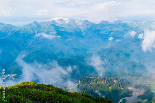 Aerial view of valley and distant mountains in blue haze from the top of mountain in Rosa Khutor, Russia © dr_verner
