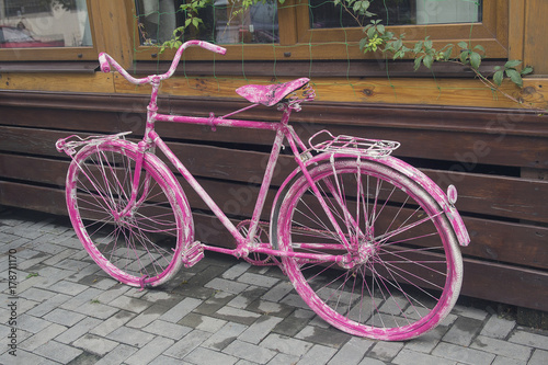 Pink vintage bicycle as a cafe decoration. Urban photo