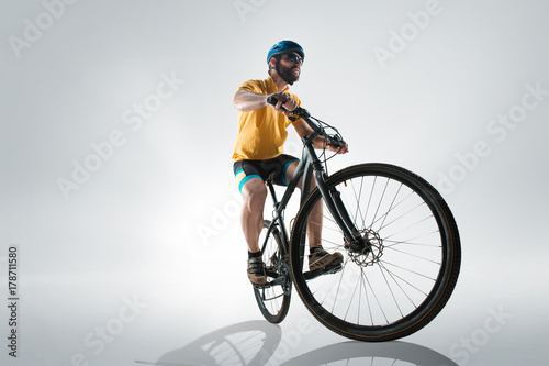 The bicyclist on gray, studio shot. © master1305