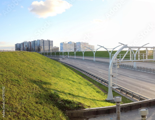 panorama of the highway and city quarters at sunset © Andrey