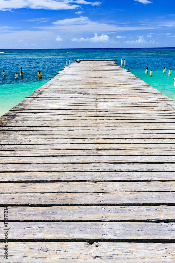 Fototapeta premium wooden bridge juts out into of the sea Dominican Republic
