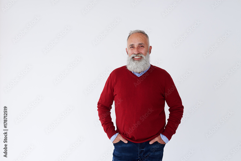 Confident bearded mature man with hands in pockets looking at camera Confident bearded mature man with hands in pockets looking at camera