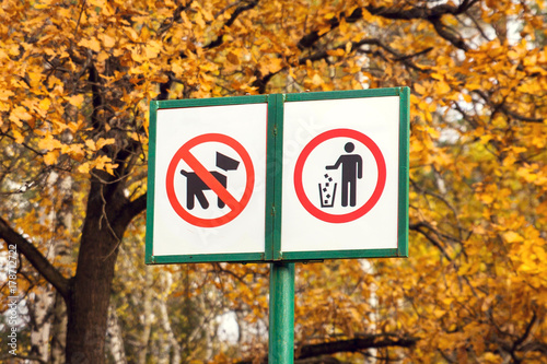 Prohibiting dog sign and prohibiting littering sign in forest