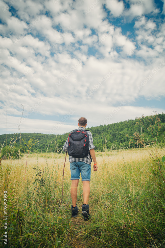 Young hiker in nature / wilderness - trekking outdoors.