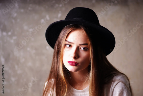 Portrait of young pensive sad in hat fashion modern woman gentle model fashion look girl