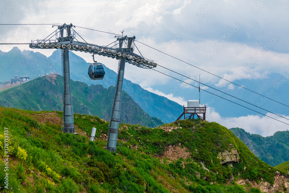 Cableway on the background of ridges, peaks and clouds in Rosa Khutor, Russia