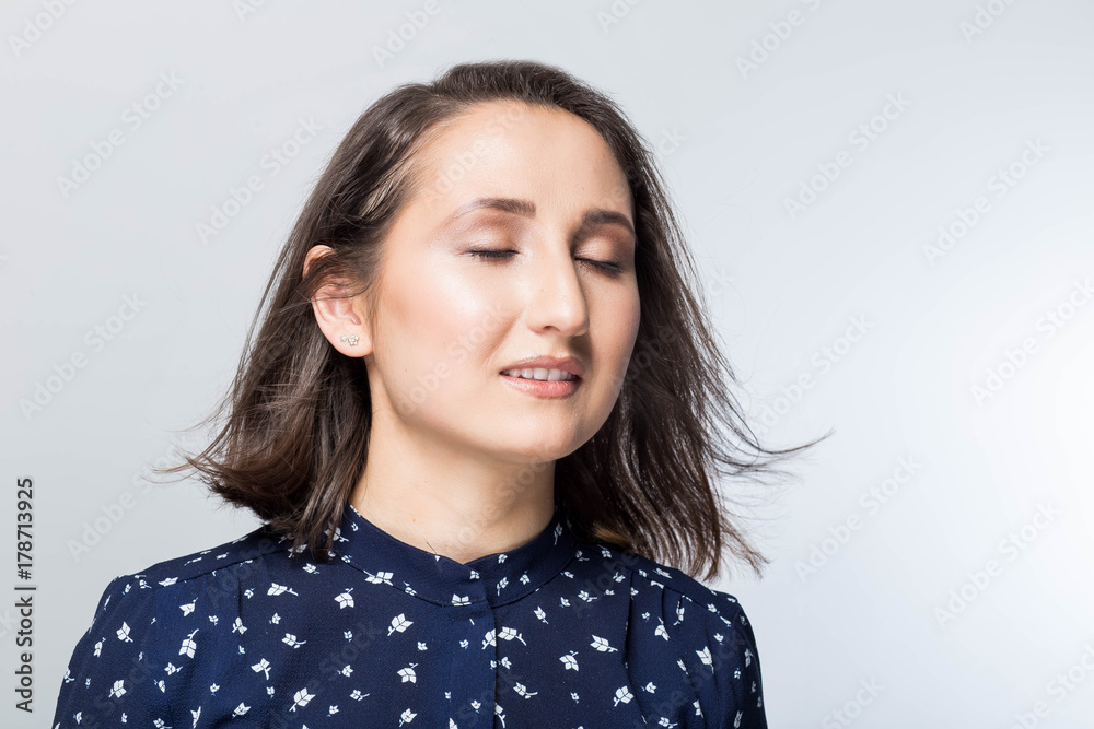 Emotional portrait of beautiful girl face with eyes closed, dreamy young brunette model. on white background, close-up Emotional portrait of beautiful girl face with eyes closed, dreamy young brunette model. on white background, close-up