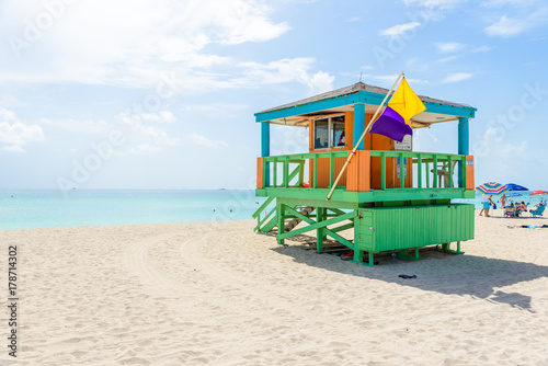Miami South Beach, lifeguard house in a colorful Art Deco style at sunny summer day with the Caribbean sea in background, world famous travel location in Florida, USA