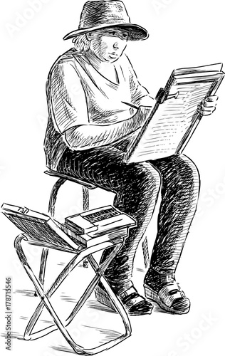 Artist woman draws on a street