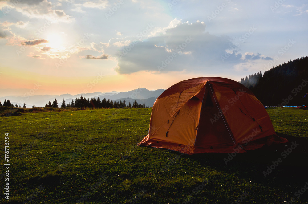 tent in the sunset overlooking mountains and a valley