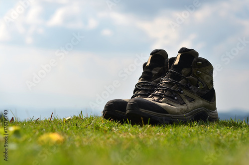 hiking boots at the grass and background mountains 