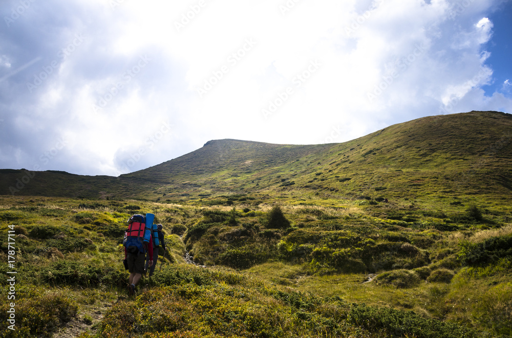 hikers walking in mountains