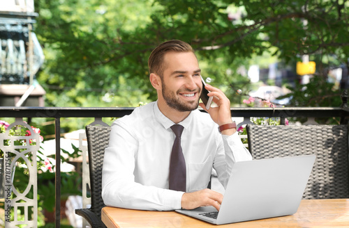 Elegant man with laptop tal...