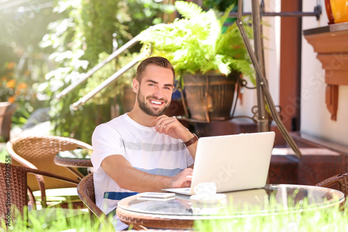 Handsome man with laptop re...