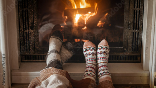 Couple feet lying by the fireplace