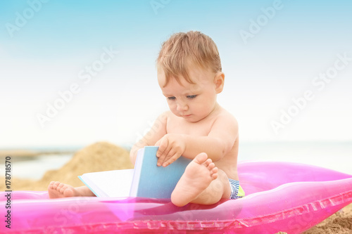 Cute baby boy sitting on in...