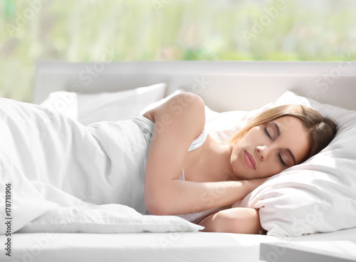 Young woman sleeping in bed...