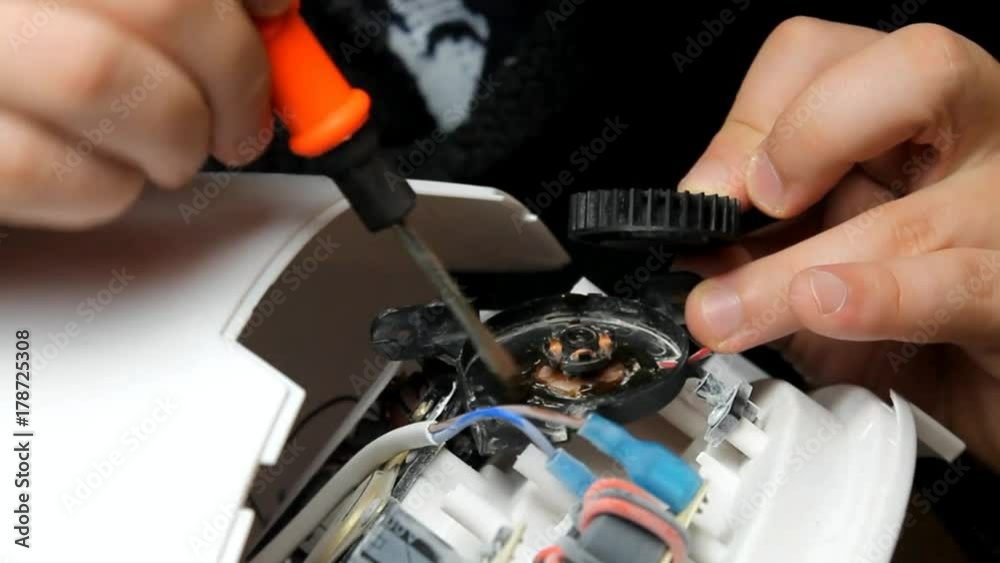Stockvideon Man repairs and lubricates the cooler of technology. repair