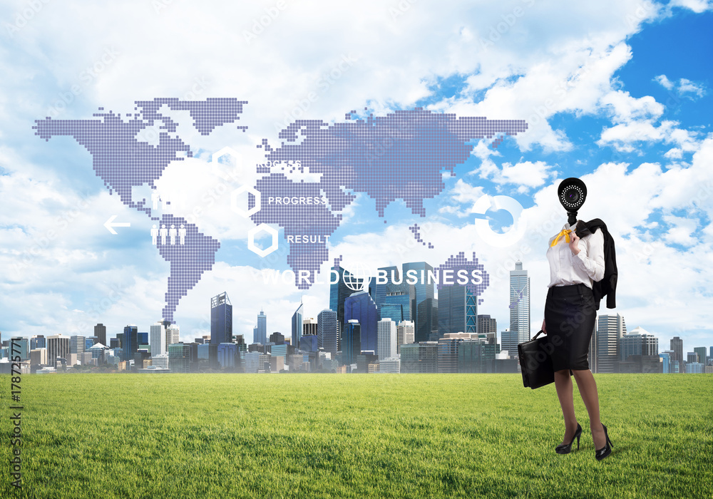 Camera headed woman standing on green grass against modern cityscape Camera headed woman standing on green grass against modern cityscape