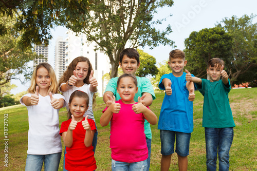 Group of happy kids showing thumbs up