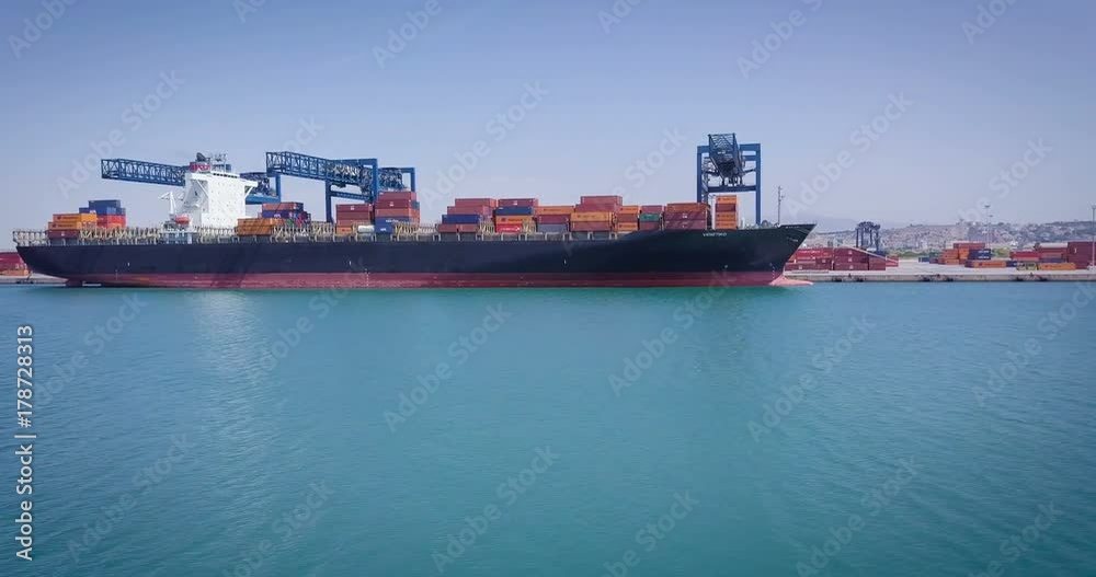 Aerial view of an industrial port where freight loads are carried for national and international shipping by sea or ocean on cargo ships. Concept of: transportation, ships, trade. Aerial view of an industrial port where freight loads are carried for national and international shipping by sea or ocean on cargo ships. Concept of: transportation, ships, trade.