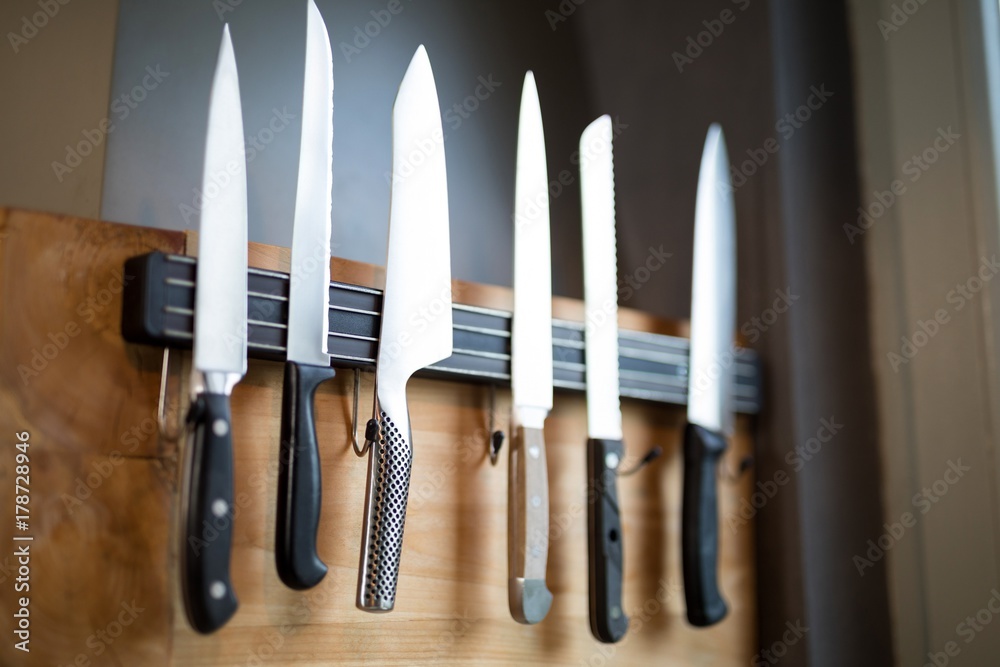 Set of kitchen knives hanging on the wall - obrazy, fototapety, plakaty 