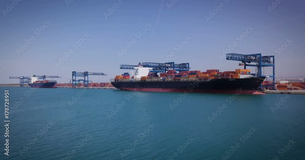Aerial view of an industrial port where freight loads are carried for national and international shipping by sea or ocean on cargo ships. Concept of: transportation, ships, trade. Aerial view of an industrial port where freight loads are carried for national and international shipping by sea or ocean on cargo ships. Concept of: transportation, ships, trade.
