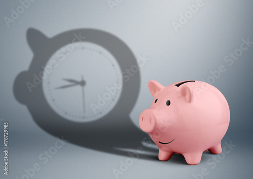 time is money concept, piggy bank with clock shadow