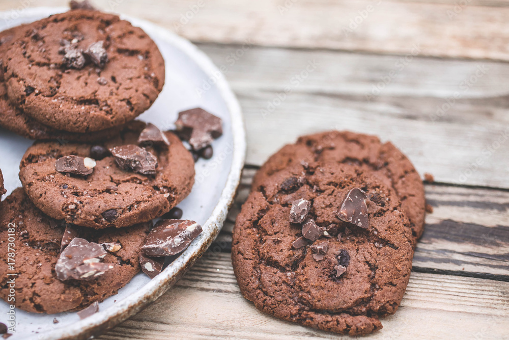 Fototapeta premium Oatmeal cookies with chocolate pieces on a wooden background