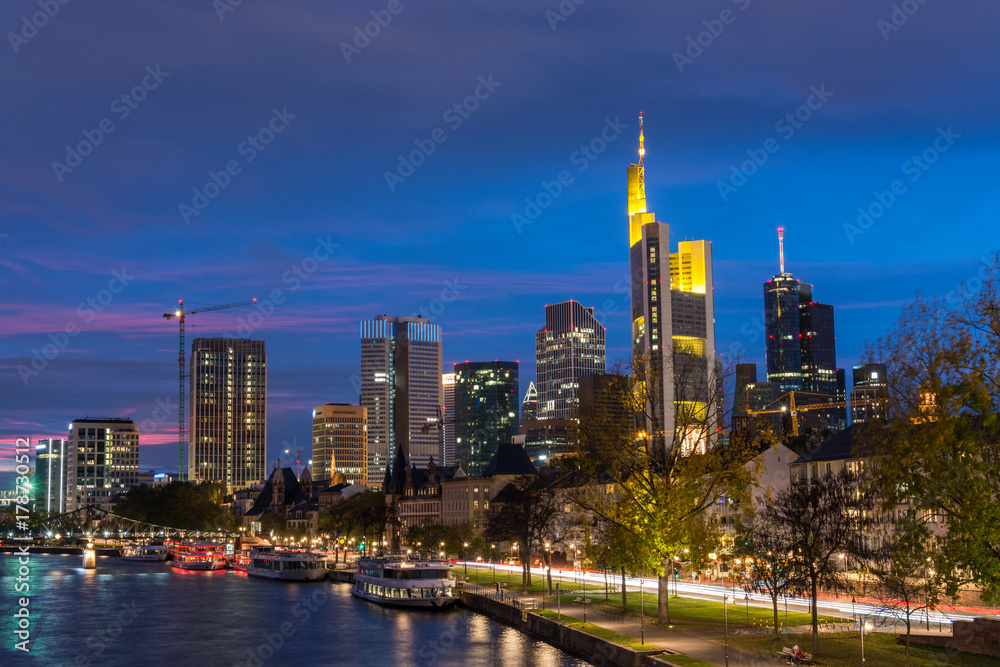 The skyline of Frankfurt with the river Main during blue hour close up