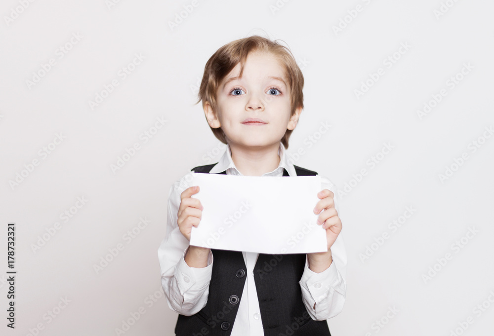 Happy young blond boy holding blank for poster in hands isolated on white background. Happy young blond boy holding blank for poster in hands isolated on white background.