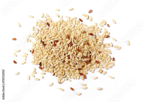 Integral, brown rice pile isolated on white background, top view