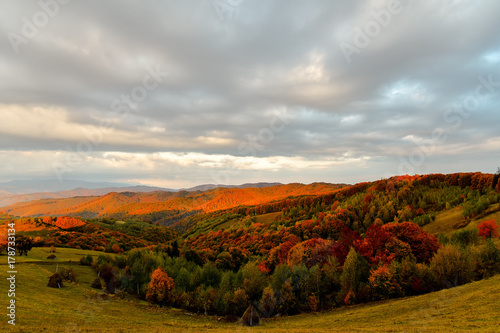 Stunning autumn nature with misty landscape Holbav village Carpathians Transylvania Romania Europe