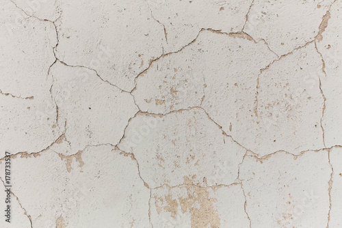 Cracked walls of the building and flaky paint