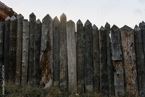 Wooden fence of thick logs