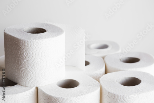 White toilet paper rolls on the gray background. Hygiene concept. photo