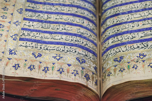 Reading the ancient Holy Quran. The open book at the Islamic Arts Museum in Kuala Lumpur, Malaysia