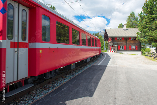 Staz station in Celerina Switzerland with the red train of the Rhaetian Alps