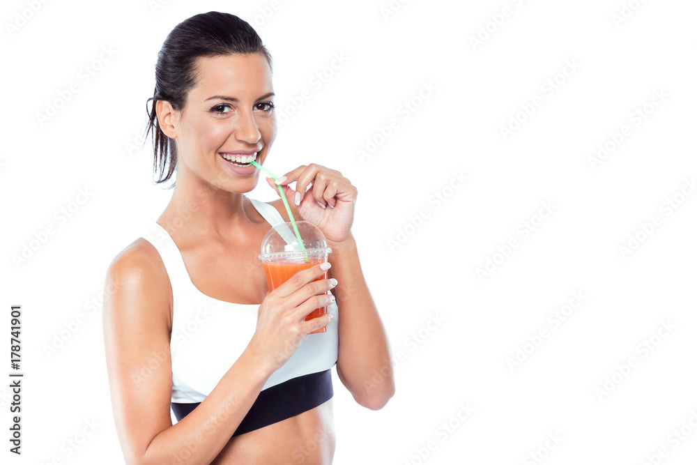 Beautiful young woman drinking detox juice over white background. Beautiful young woman drinking detox juice over white background.