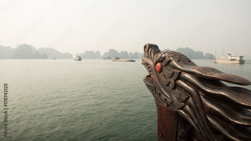 A boat with a dragon's head floating in the ocean. Vietnam. Ha Long Bay.